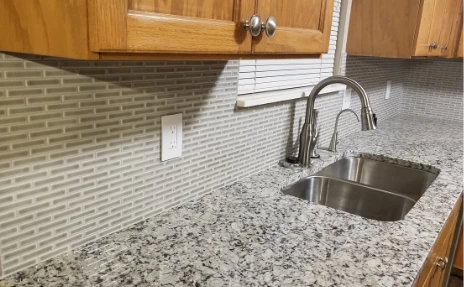 backsplash tile and granite countertops in a kitchen